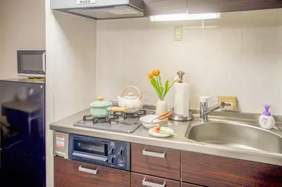 a kitchen with a sink and a stove top oven at Ikebukuro mansion,4-6people,two bedrooms,subway 5mins in Tokyo