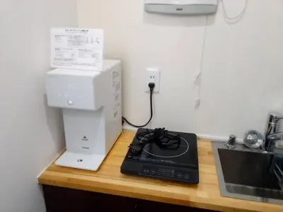 a kitchen counter with a coffee maker and a microwave at Okubo, 20 seconds walk from JR Okubo Station in Tokyo