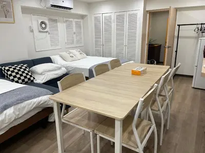 a living room with a table and a couch at Okubo, 20 seconds walk from JR Okubo Station in Tokyo