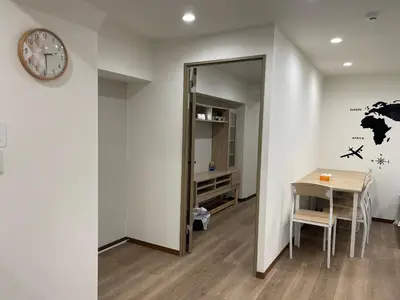 a room with a table and a clock on a wall at Okubo, 20 seconds walk from JR Okubo Station in Tokyo