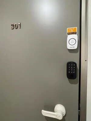 a door with a remote control next to a toilet at Okubo, 20 seconds walk from JR Okubo Station in Tokyo
