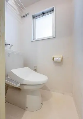 a white bathroom with a toilet and a window at Cozy Apartment, 2min to Station , Direct to Skytree, Asakusa & Ueno & Narita ,駅2分,スカイツリー浅草上野成田空港直結,エレベーター,スーパー2分,コンビニ1分 in Tokyo