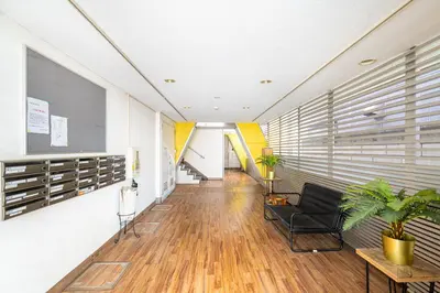 a hallway of an office with a chair and a table at Cozy Apartment, 2min to Station , Direct to Skytree, Asakusa & Ueno & Narita ,駅2分,スカイツリー浅草上野成田空港直結,エレベーター,スーパー2分,コンビニ1分 in Tokyo