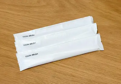 two pieces of white paper on a wooden table at Cozy Apartment, 2min to Station , Direct to Skytree, Asakusa & Ueno & Narita ,駅2分,スカイツリー浅草上野成田空港直結,エレベーター,スーパー2分,コンビニ1分 in Tokyo