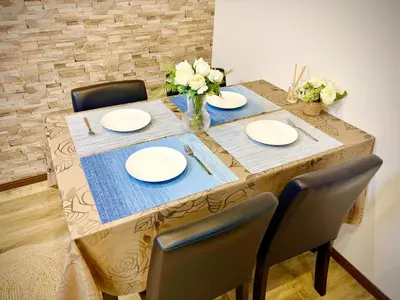 a table with chairs and plates and flowers on it at Pine House 6 minutes by train to Ikebukuro 11 minutes to Shinjuku Convenient access to Ueno by train in Tokyo