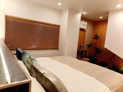a bedroom with a large bed and a window at A2 Shinjuku JR St 8 mins 3 bedrooms and 1 living room 2bathrooms 2toilets Max 12P Direct to Shinjuku Ueno Ginza Shibuya Ikebukuro Yoyogi Shinagawa \u65b0\u5bbf\u533a \u9ad8\u7530\u9a6c\u573a\u8f66\u7ad98\u5206\u949f 3\u5ba41\u53852\u6d74\u5ba42\u536b\u751f\u95f4 \u6700\u592712\u4eba in Tokyo