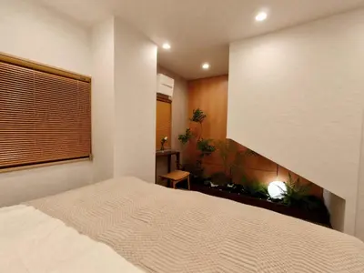 a bedroom with a bed and a window and plants at A2 Shinjuku JR St 8 mins 3 bedrooms and 1 living room 2bathrooms 2toilets Max 12P Direct to Shinjuku Ueno Ginza Shibuya Ikebukuro Yoyogi Shinagawa \u65b0\u5bbf\u533a \u9ad8\u7530\u9a6c\u573a\u8f66\u7ad98\u5206\u949f 3\u5ba41\u53852\u6d74\u5ba42\u536b\u751f\u95f4 \u6700\u592712\u4eba in Tokyo