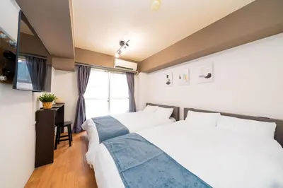 a bedroom with two beds and a window at Newly opened! 4 minutes on foot from Shin-Okubo station in Tokyo