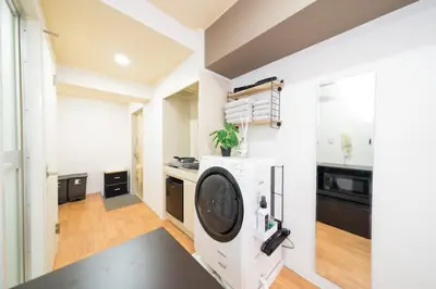 a kitchen with white walls and a black counter at Newly opened! 4 minutes on foot from Shin-Okubo station in Tokyo