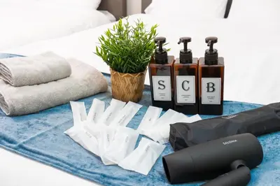 a table with three bottles of essential oils and towels at Newly opened! 4 minutes on foot from Shin-Okubo station in Tokyo