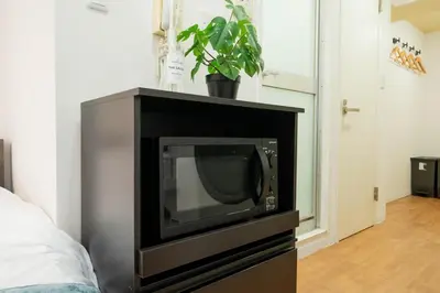a television sitting on top of a cabinet at Newly opened! 4 minutes on foot from Shin-Okubo station in Tokyo