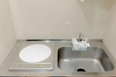 a kitchen sink with a mirror and a faucet at Newly opened! 4 minutes on foot from Shin-Okubo station in Tokyo