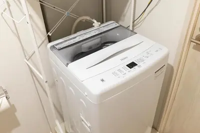 a washer and dryer in a laundry room at KOU Jiyugaoka 101 in Tokyo