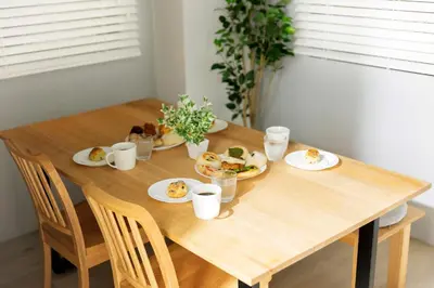 a wooden table with plates of food on it at KOU Jiyugaoka 101 in Tokyo