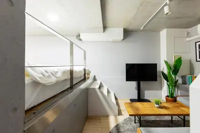 a bedroom with a bunk bed and a wooden table at KOU Jiyugaoka 101 in Tokyo