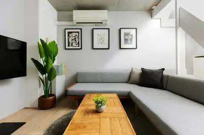 a living room with a couch and a coffee table at KOU Jiyugaoka 101 in Tokyo
