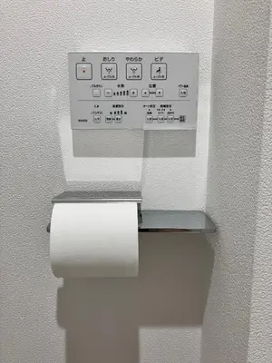 a toilet paper dispenser with a roll of toilet paper at KOU Jiyugaoka 202 in Tokyo