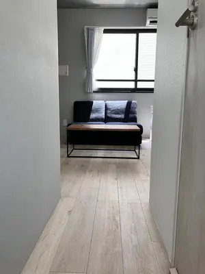 a couch sitting in a room with a window at KOU Jiyugaoka 202 in Tokyo