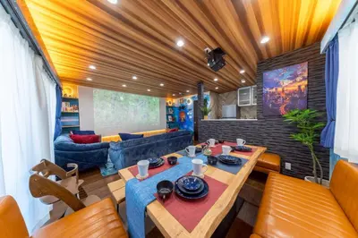 a living room with a table and a couch at 3 minutes from Sangenjaya 90square meters 50square meters rooftop 3LDK Relaxing Tokyo stay with rooftop, jacuzzi projector in Tokyo