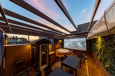 a balcony with a tv and a table and chairs at 3 minutes from Sangenjaya 90square meters 50square meters rooftop 3LDK Relaxing Tokyo stay with rooftop, jacuzzi projector in Tokyo