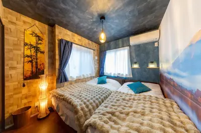 a bedroom with a large bed and two windows at 3 minutes from Sangenjaya 90square meters 50square meters rooftop 3LDK Relaxing Tokyo stay with rooftop, jacuzzi projector in Tokyo
