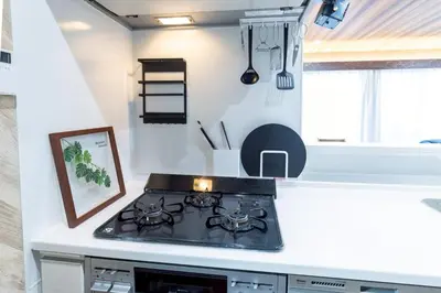 a stove top oven in a kitchen next to a window at 3 minutes from Sangenjaya 90square meters 50square meters rooftop 3LDK Relaxing Tokyo stay with rooftop, jacuzzi projector in Tokyo