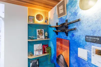 a room with a blue wall with a gun on the wall at 3 minutes from Sangenjaya 90square meters 50square meters rooftop 3LDK Relaxing Tokyo stay with rooftop, jacuzzi projector in Tokyo