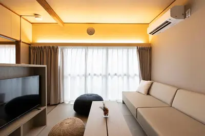 a living room with a couch and a television at KOU Ikebukuro in Tokyo