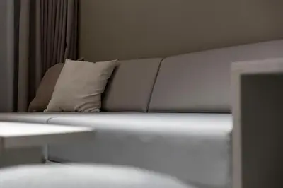 a white couch with a pillow in a room at KOU Ikebukuro in Tokyo