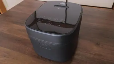 a black computer printer sitting on a wooden table at Ninja Tokyo Hideaway Higashi-Shinkoiwa in Tokyo