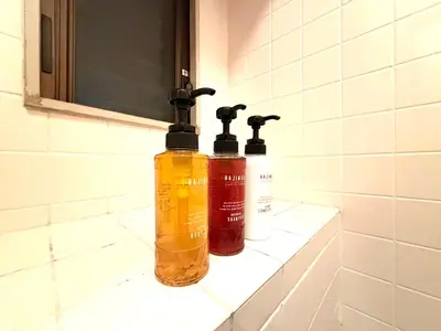 two bottles ofodorizers are sitting on a bathroom sink at Ninja Tokyo Hideaway Higashi-Shinkoiwa in Tokyo