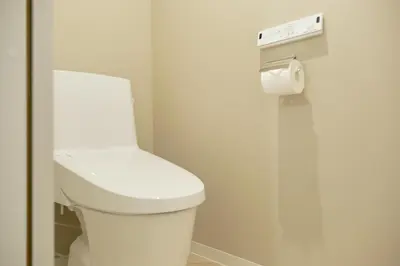 a bathroom with a toilet and a roll of toilet paper at The underz suite residence Ikebukuro by Tranova in Tokyo