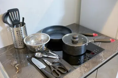 a stove top with pots and pans on a counter at The underz suite residence Ikebukuro by Tranova in Tokyo