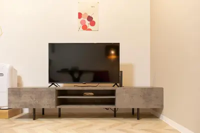 a living room with a television on a table at The underz suite residence Ikebukuro by Tranova in Tokyo