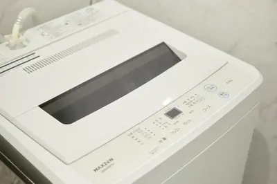 a white washing machine sitting on a counter at The underz suite residence Ikebukuro by Tranova in Tokyo
