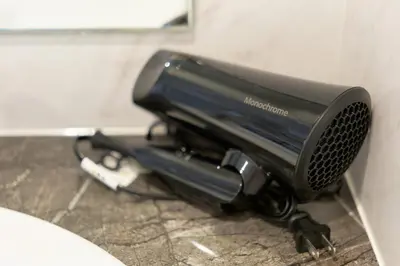 a hair dryer is attached to a wall at The underz suite residence Ikebukuro by Tranova in Tokyo