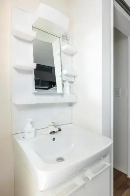a white bathroom with a sink and a mirror at TRUSS 2nd in Tokyo