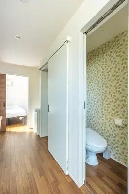 a bathroom with a toilet and a bedroom at TRUSS 2nd in Tokyo