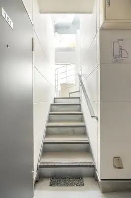 a staircase in a building with a glass door at TRUSS 2nd in Tokyo