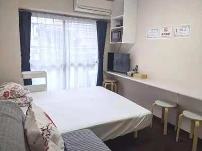 a hospital room with two beds and a window at A Stay in Shinjuku in Tokyo