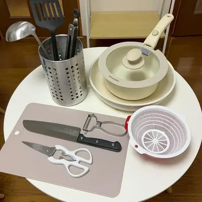 a white table with a cutting board with a fan and scissors at \u83ef -Hana- in Tokyo