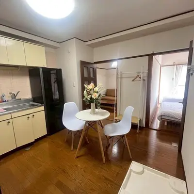 a kitchen with a table with a vase of flowers on it at \u83ef -Hana- in Tokyo