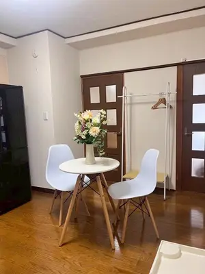 a table with white chairs and a vase of flowers on it at \u83ef -Hana- in Tokyo