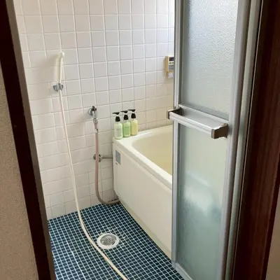 a bathroom with a shower with a tub and a sink at \u83ef -Hana- in Tokyo