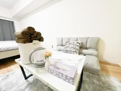 a living room with a couch and a coffee table at Ikebukuro Cozy \u30cf\u30a6\u30b95 in Tokyo