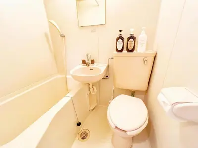 a small bathroom with a toilet and a sink at Ikebukuro Cozy \u30cf\u30a6\u30b95 in Tokyo