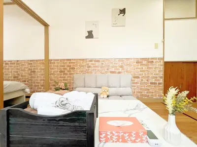 a bedroom with a bed and a brick wall at Nogata Relaxing Home C1 in Tokyo