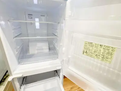 an empty refrigerator with its door open in a kitchen at Nogata Relaxing Home C1 in Tokyo