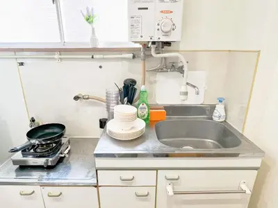 a kitchen counter with a sink and a stove at Nogata Relaxing Home C1 in Tokyo