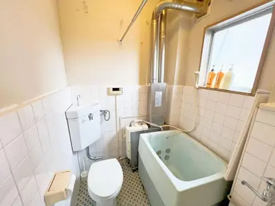 a bathroom with a toilet and a bath tub at Nogata Relaxing Home C1 in Tokyo
